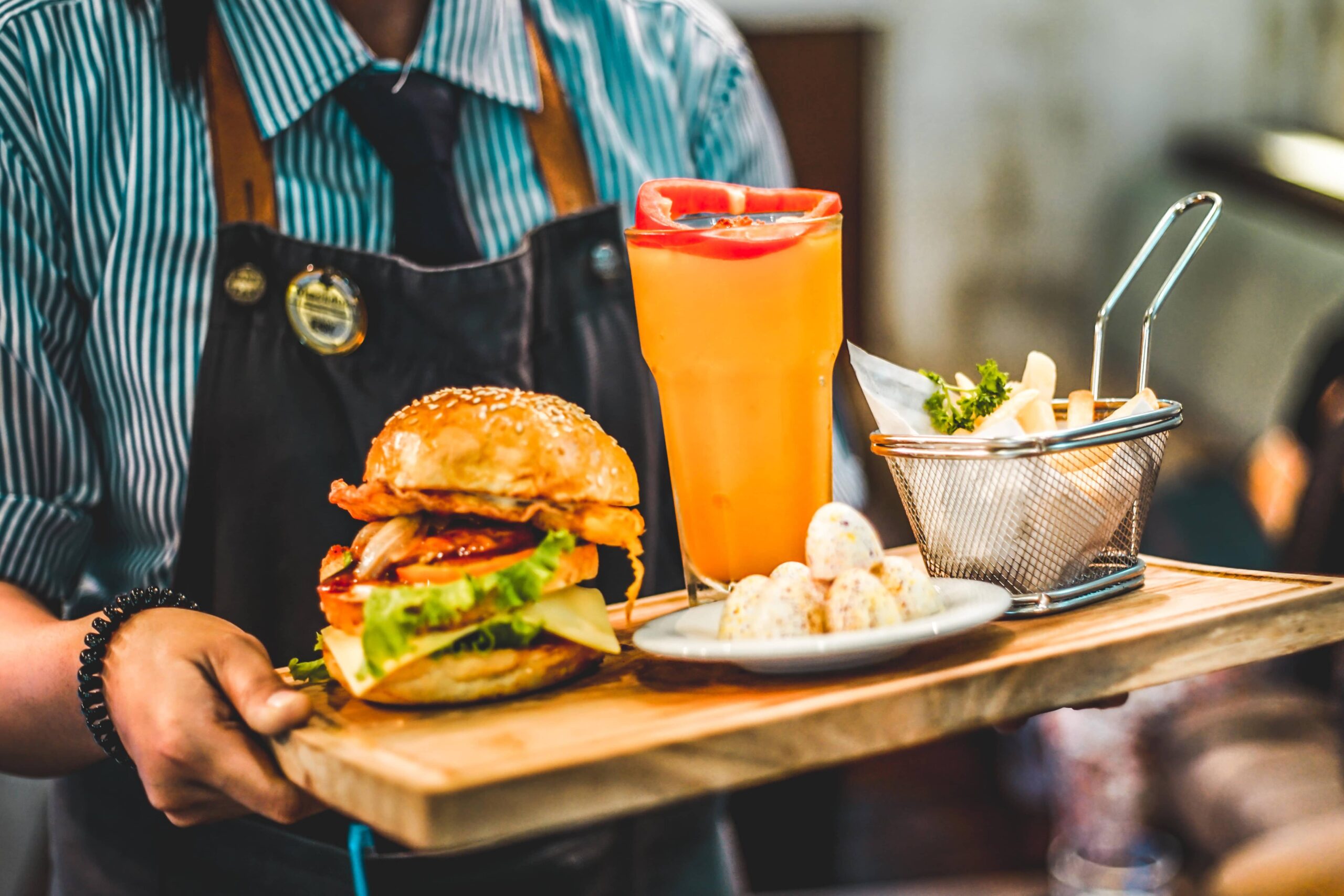waiter carrying tray of food